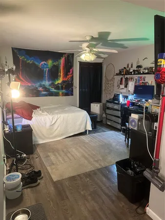 a bedroom with furniture and a flat screen tv