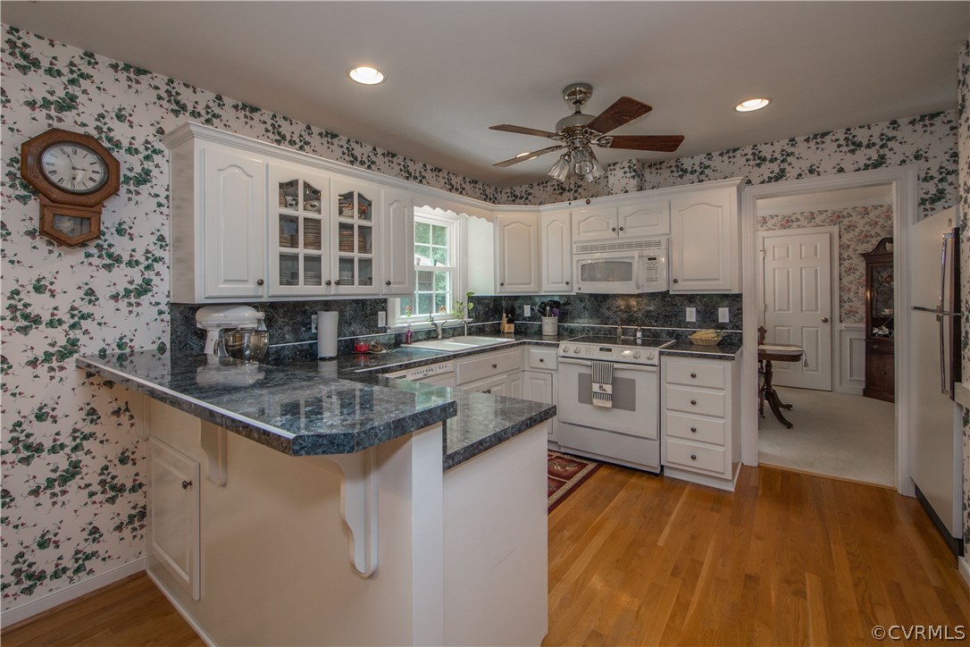 12941 Spring Run Road Midlothian, VA 23112 - Photo 11 of 48 a kitchen with stainless steel appliances granite countertop a lot of counter space and wooden floors