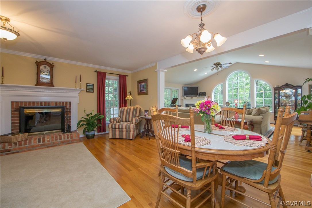 12941 Spring Run Road Midlothian, VA 23112 - Photo 16 of 48 a view of a dining room with furniture a chandelier and wooden floor