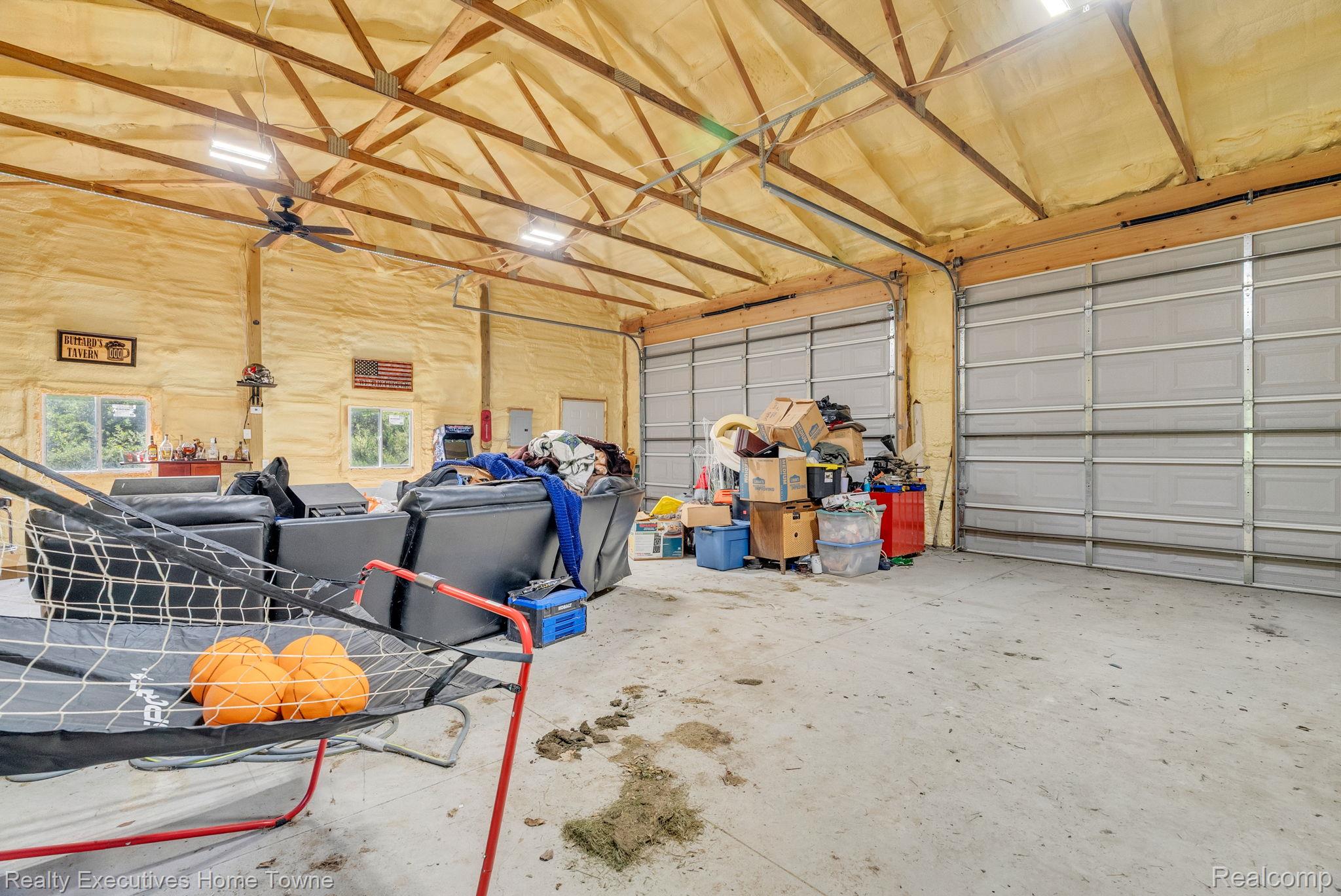 6560 Roach Road Lexington, MI 48450 - Photo 34 of 36 Spacious interior features exposed wood ceiling trusses, insulated walls, and two large roll-up doors