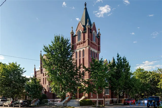 a view of a building with a tree in the background