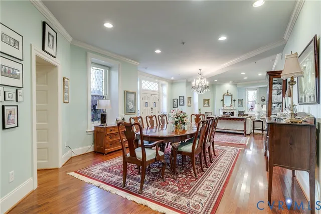 a dining room with wooden floor a glass table and chairs