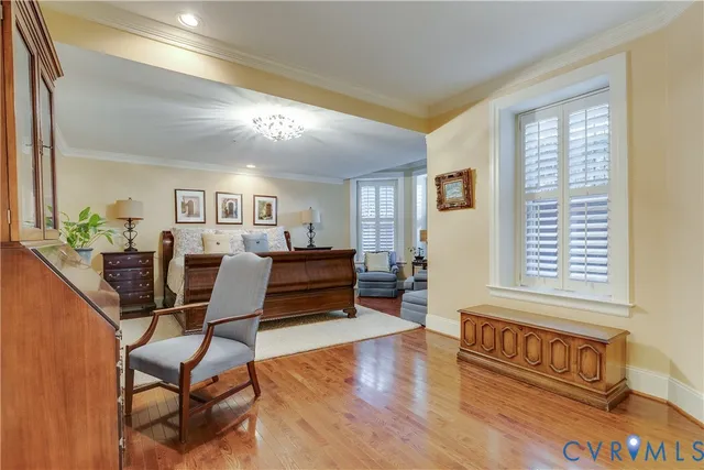 a living room with furniture wooden floor and a window