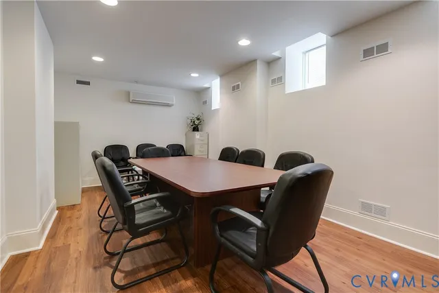 a view of a brick house with a small yard and wooden fence