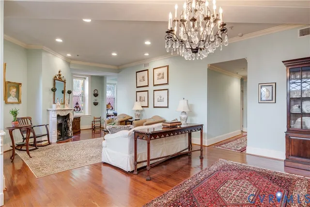 a living room with furniture and a chandelier