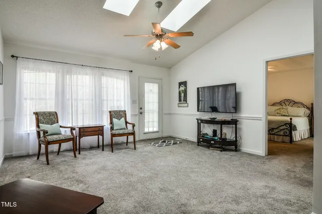 a view of a livingroom with furniture and a flat screen tv