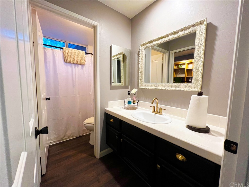 43 Corte Rivera Lake Elsinore, CA 92532 - Photo 13 of 32 a bathroom with a double vanity sink and a mirror