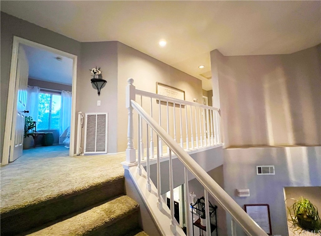 43 Corte Rivera Lake Elsinore, CA 92532 - Photo 16 of 32 a view of a livingroom with furniture and stairs