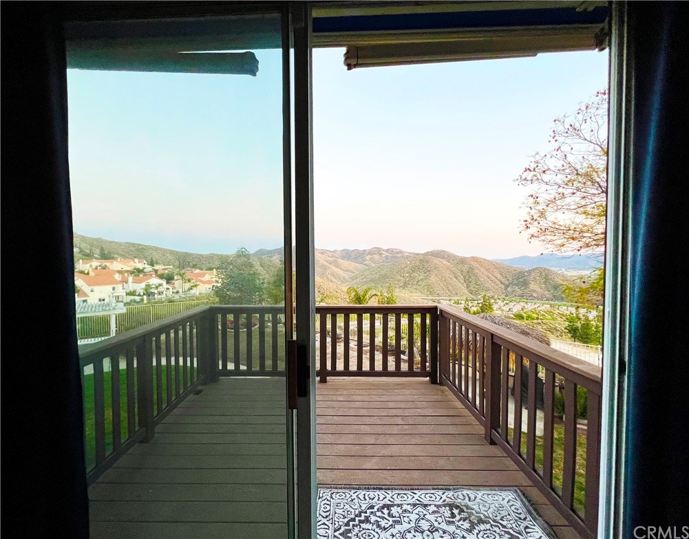 43 Corte Rivera Lake Elsinore, CA 92532 - Photo 23 of 32 a view of a glass door with a balcony from a window