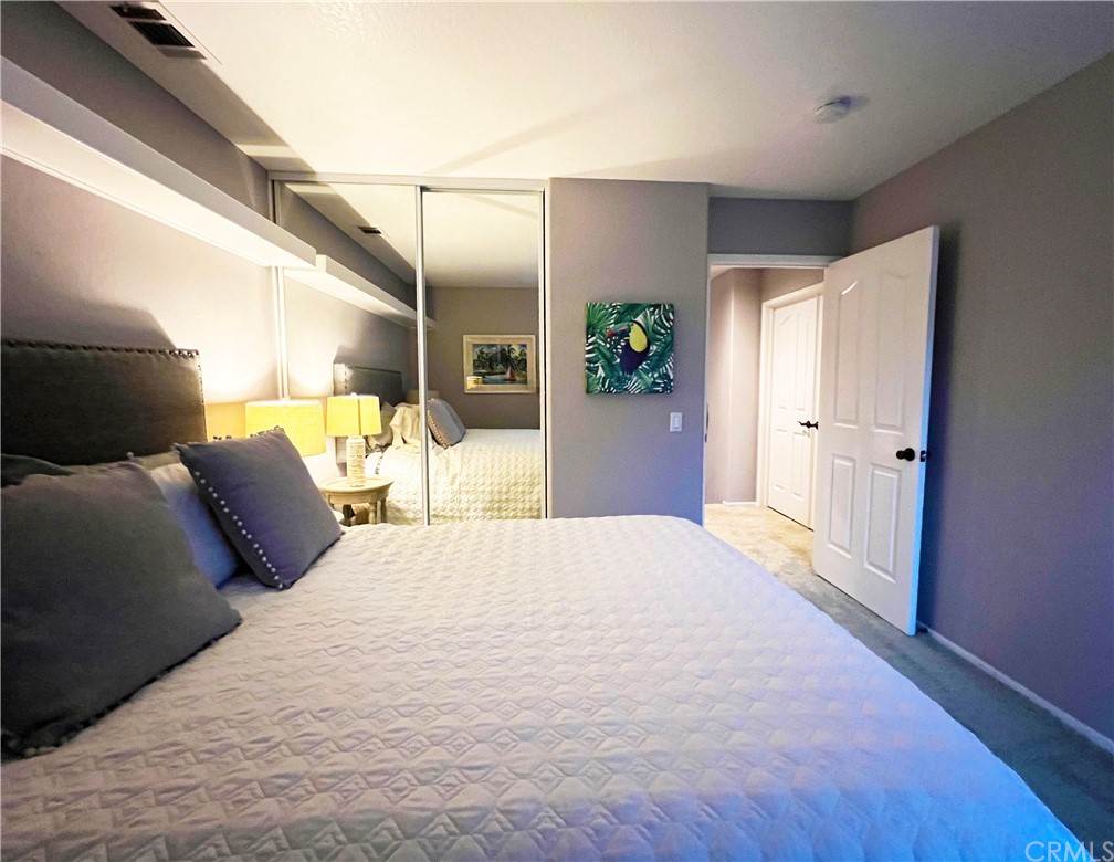 43 Corte Rivera Lake Elsinore, CA 92532 - Photo 26 of 32 a large bedroom with a bed and wooden floor