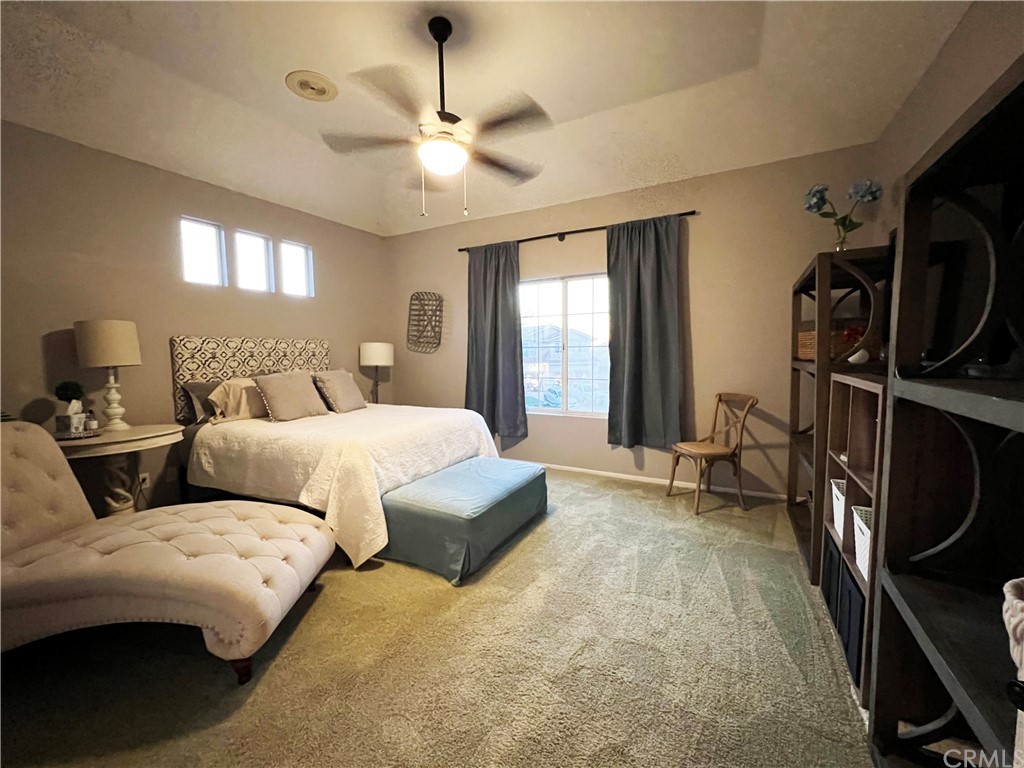 43 Corte Rivera Lake Elsinore, CA 92532 - Photo 30 of 32 a bedroom with bed and a chandelier