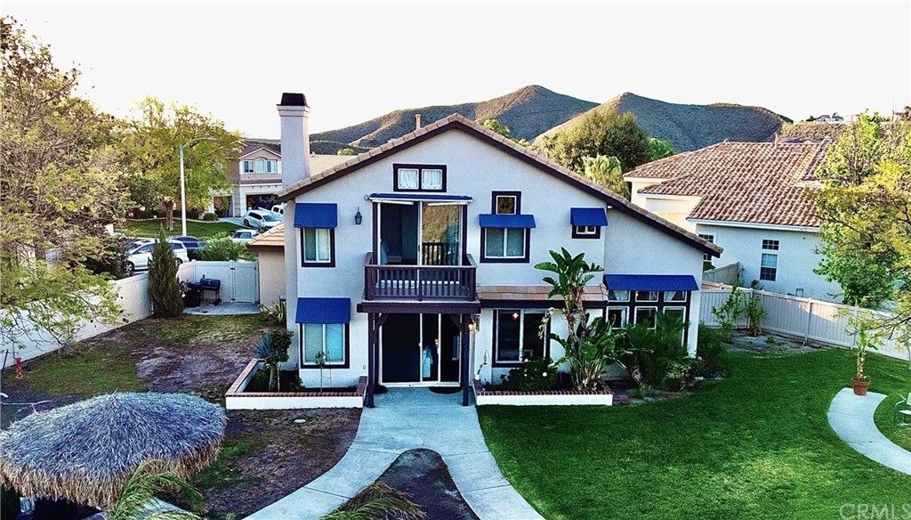43 Corte Rivera Lake Elsinore, CA 92532 - Photo 3 of 32 a front view of a house with garden