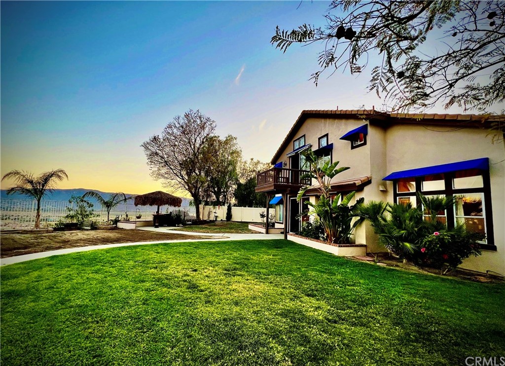 43 Corte Rivera Lake Elsinore, CA 92532 - Photo 4 of 32 a front view of house with yard and trees in the background