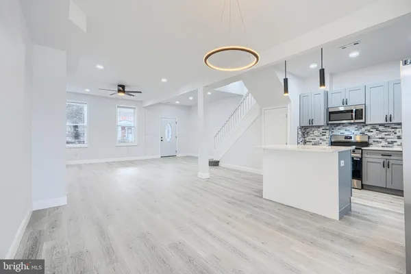 a view of kitchen with sink and wooden floor