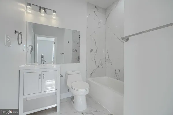 a bathroom with a toilet sink and a bathtub