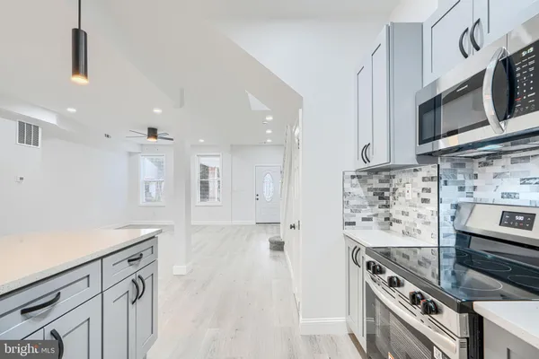 a kitchen with stainless steel appliances granite countertop a stove and a sink
