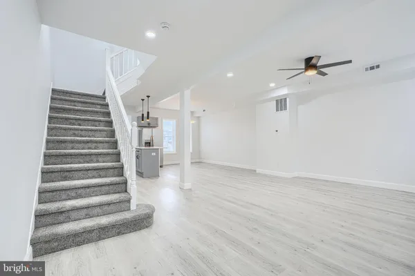 an entryway in hall with a ceiling fan