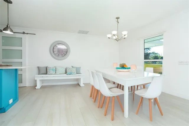 a kitchen with stainless steel appliances white cabinets and a stove a refrigerator with wooden floor
