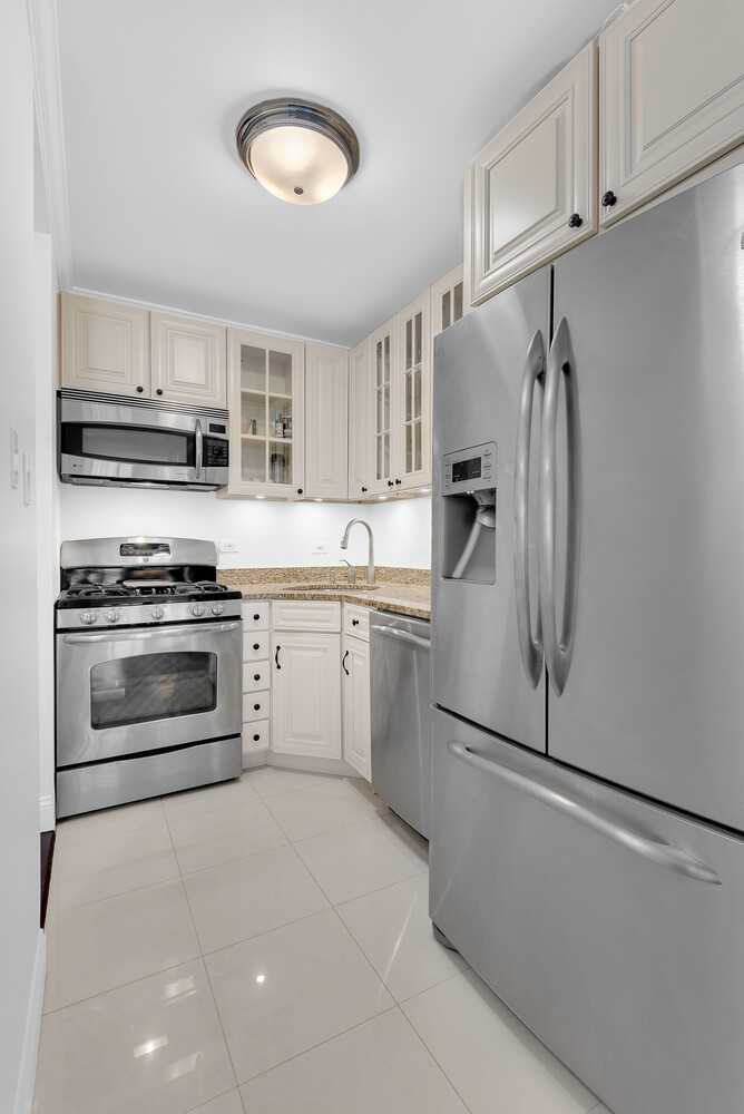 330 East 75th Street, Unit 4B Manhattan, NY 10021 - Photo 4 of 12 a kitchen with a refrigerator stove and microwave
