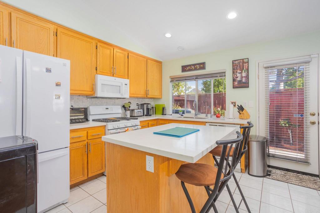 4895 Lake Shore Place Fallbrook, CA 92028 - Photo 4 of 27 a kitchen with stainless steel appliances granite countertop a stove a refrigerator a kitchen island a stove and a refrigerator with cabinets