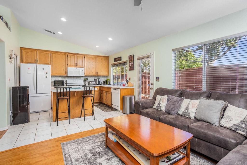 4895 Lake Shore Place Fallbrook, CA 92028 - Photo 6 of 27 a living room with stainless steel appliances furniture a rug and a kitchen view