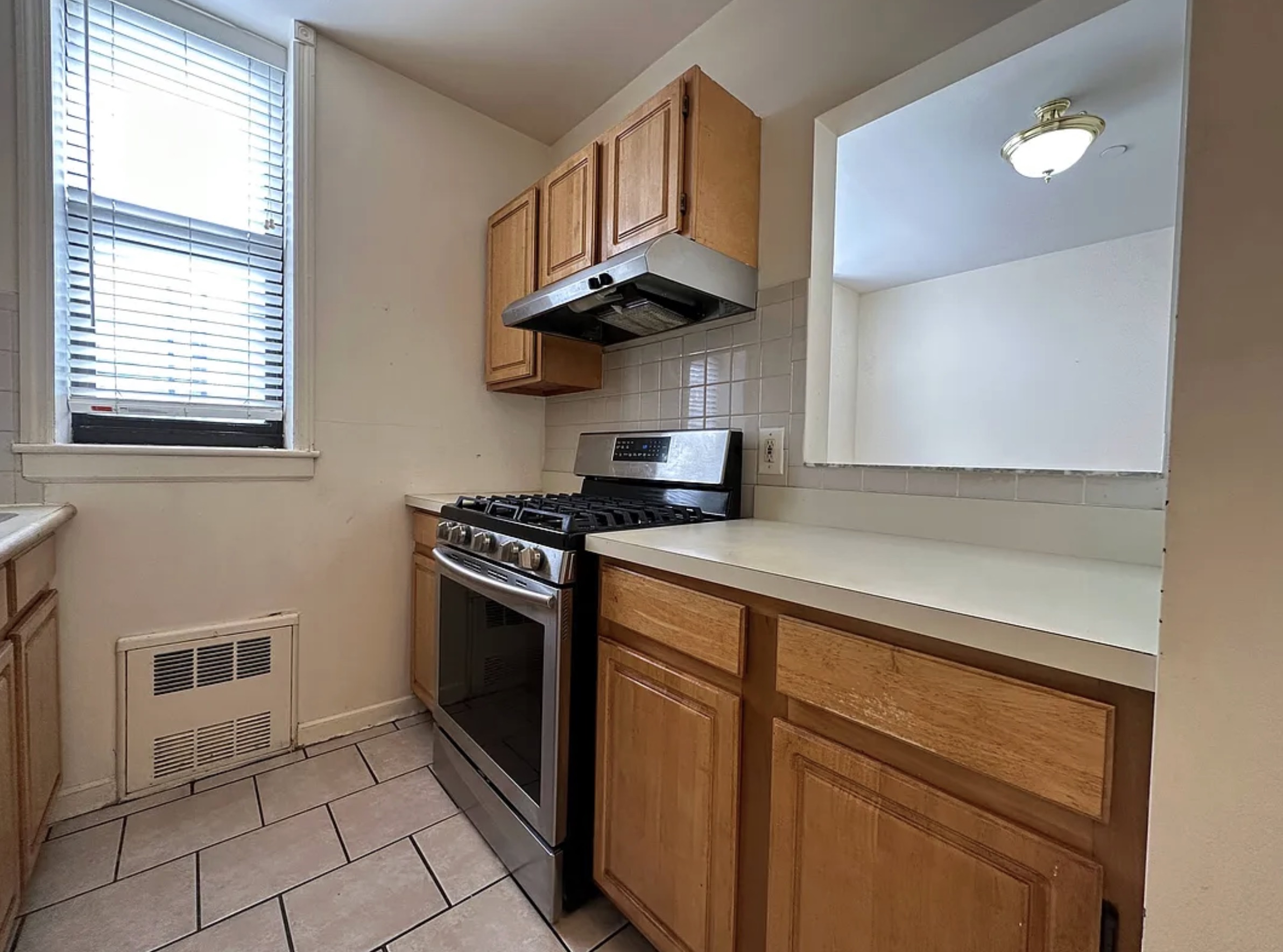Undisclosed Address Manhattan, NY 10032 - Photo 5 of 8 a kitchen with stainless steel appliances granite countertop a stove a sink and a microwave