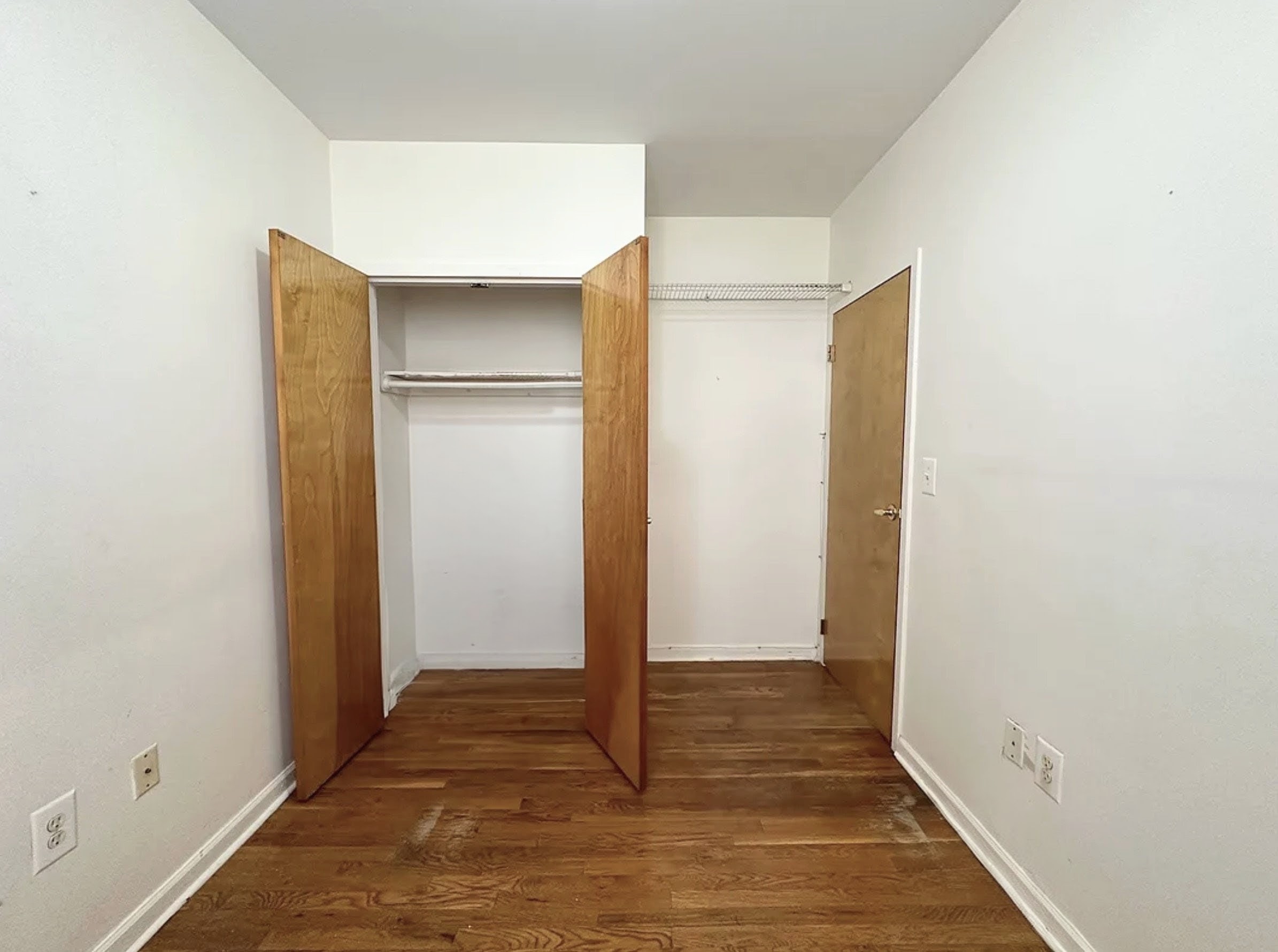 Undisclosed Address Manhattan, NY 10032 - Photo 7 of 8 a view of a hallway with wooden floor