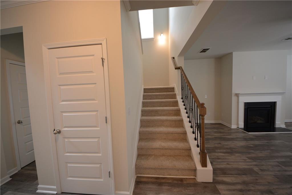 2377 Ticonic Road Lithonia, GA 30058 - Photo 13 of 40 a view of a hallway with wooden floor and a fireplace