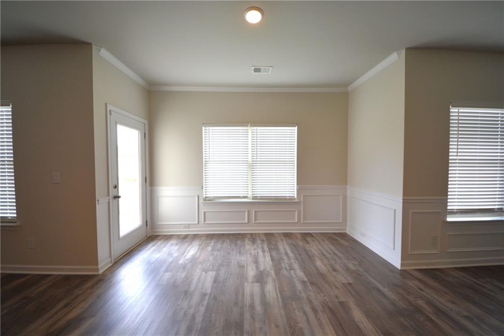 2377 Ticonic Road Lithonia, GA 30058 - Photo 21 of 40 an empty room with wooden floor and windows