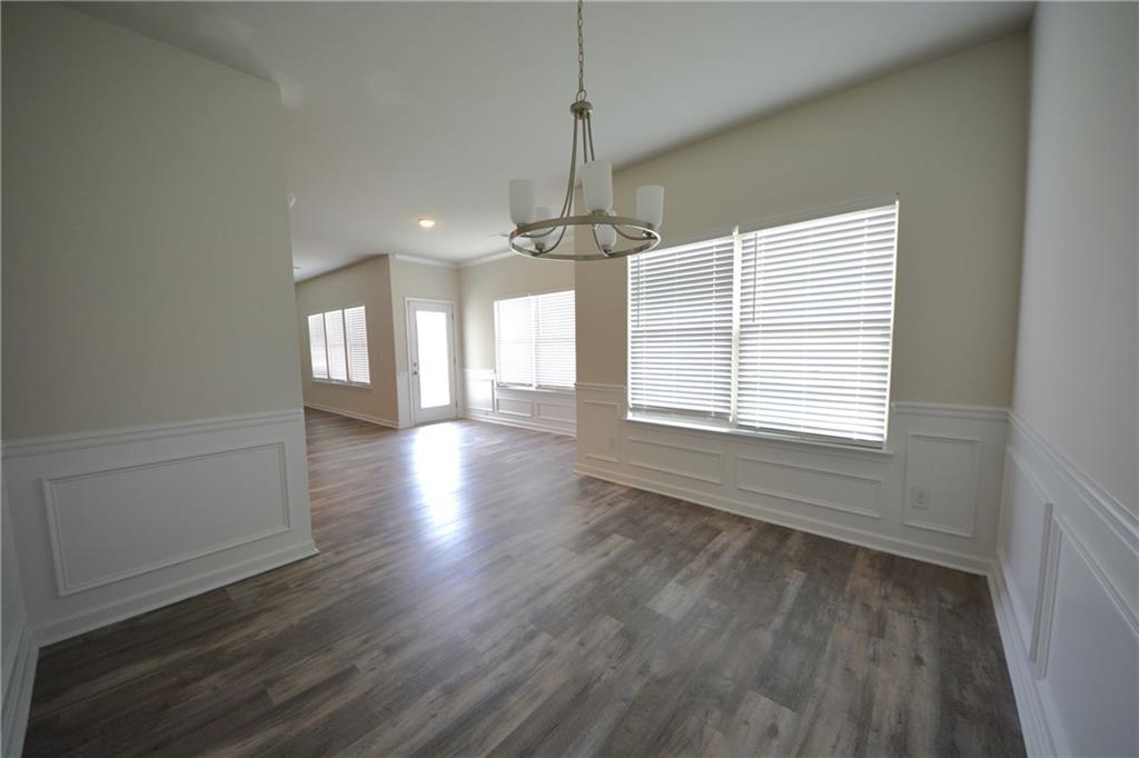 2377 Ticonic Road Lithonia, GA 30058 - Photo 23 of 40 a view of an empty room with wooden floor and a window