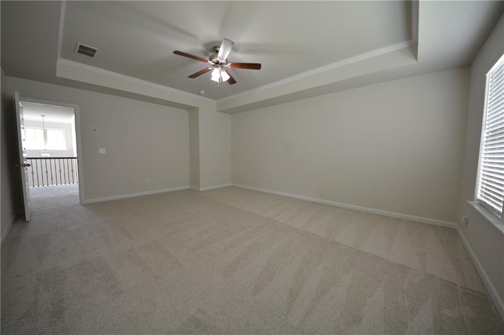 2377 Ticonic Road Lithonia, GA 30058 - Photo 29 of 40 en empty room with windows and chandelier fan