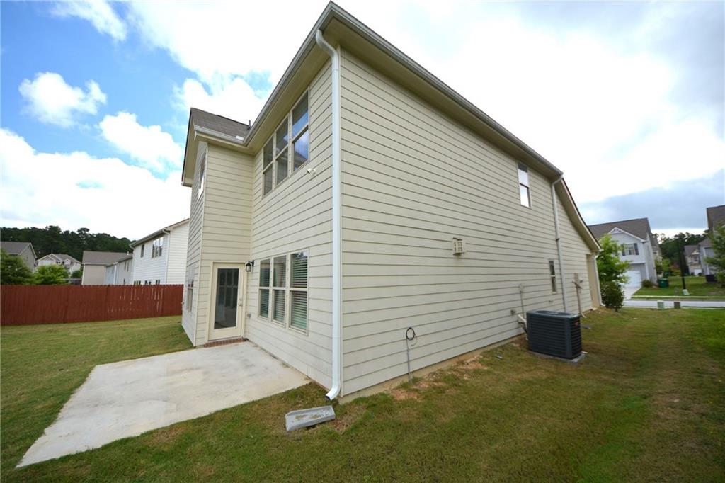 2377 Ticonic Road Lithonia, GA 30058 - Photo 6 of 40 a view of a white house with a yard