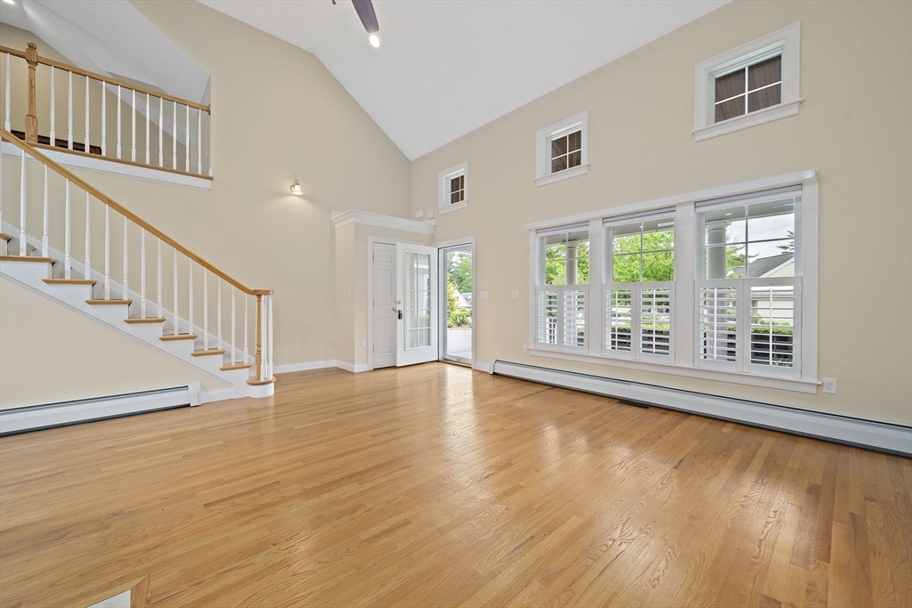 14 Sugar Maple Circle, Unit 14 Hanover, MA 02339 - Photo 11 of 38 a view of an empty room with wooden floor and a window