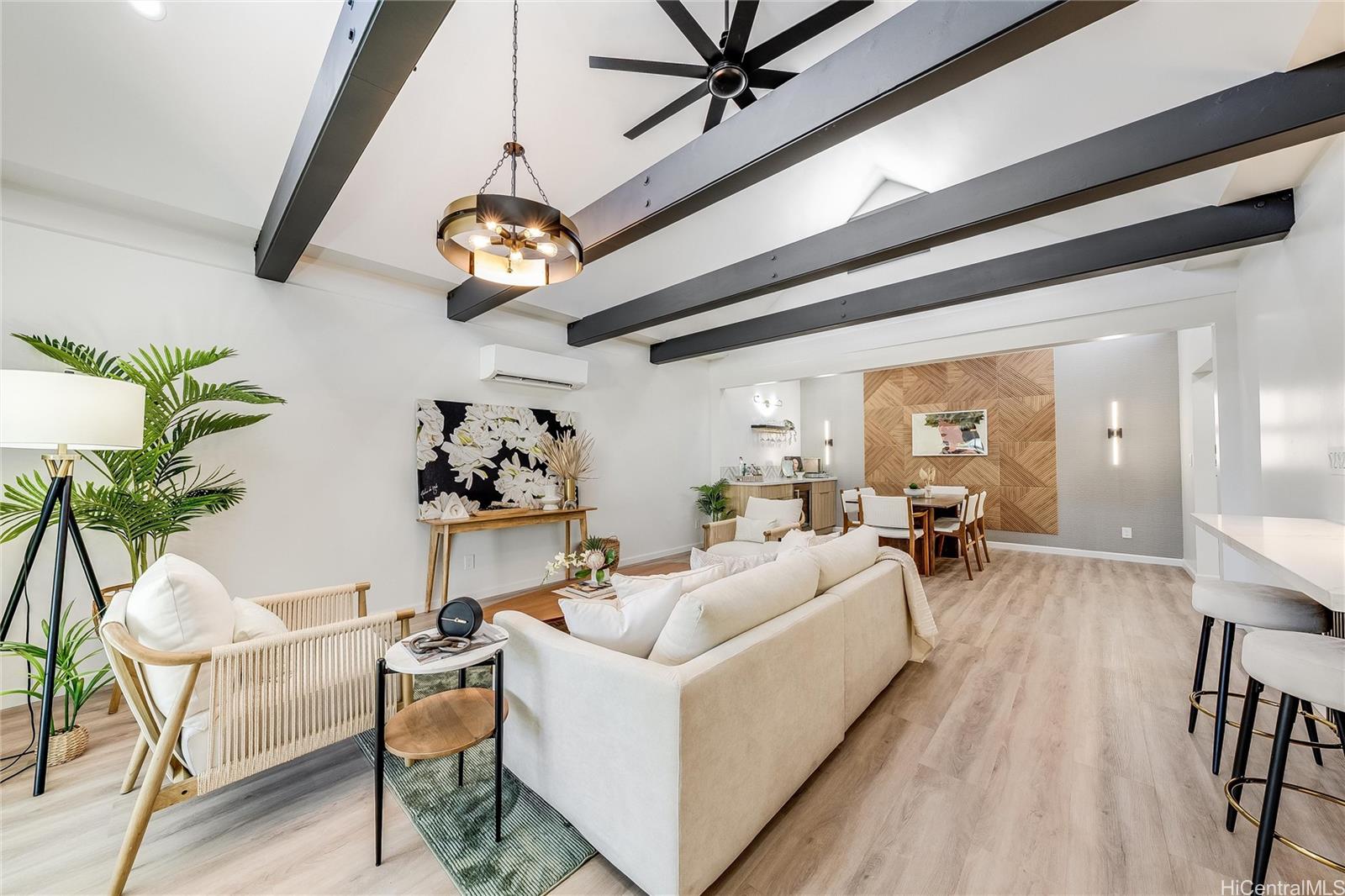 a living room with furniture dining table and a chandelier