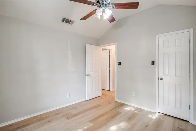 a view of an empty room and wooden floor