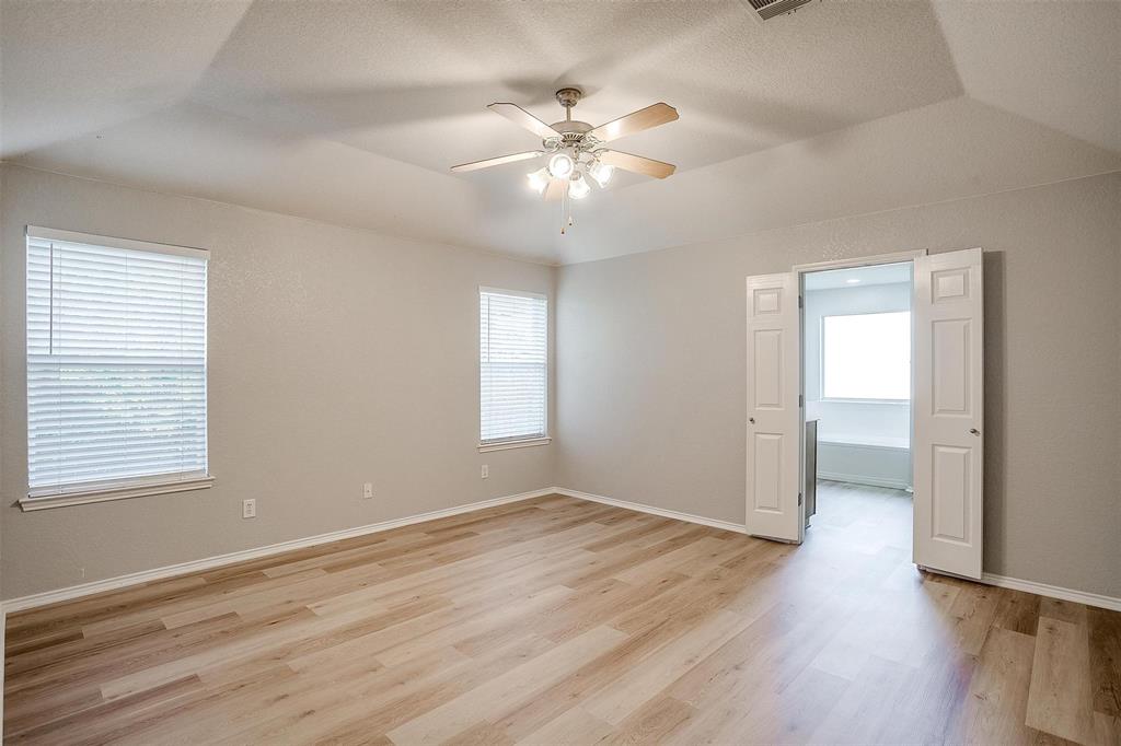543 Thistle Meade Circle Burleson, TX 76028 - Photo 17 of 23 a view of an empty room with wooden floor and a window