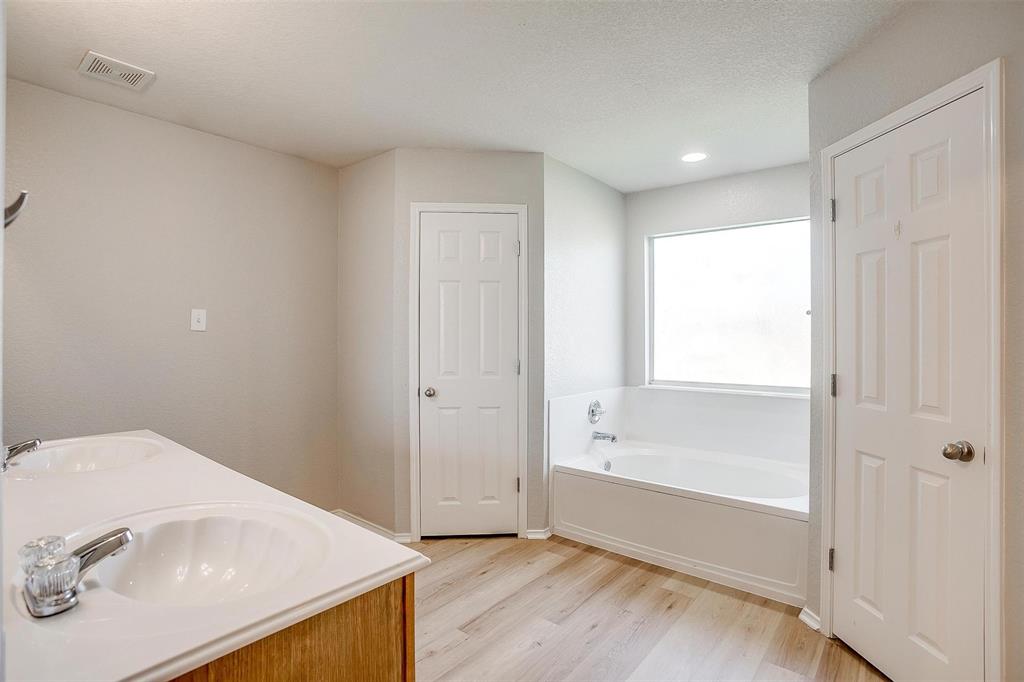 543 Thistle Meade Circle Burleson, TX 76028 - Photo 19 of 23 a bathroom with a tub and shower