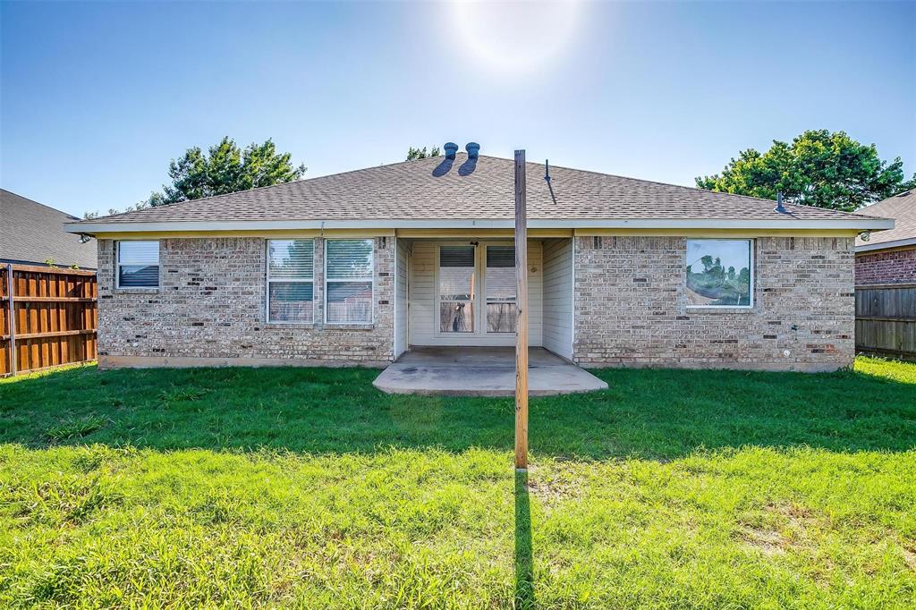543 Thistle Meade Circle Burleson, TX 76028 - Photo 21 of 23 a front view of a house with a garden