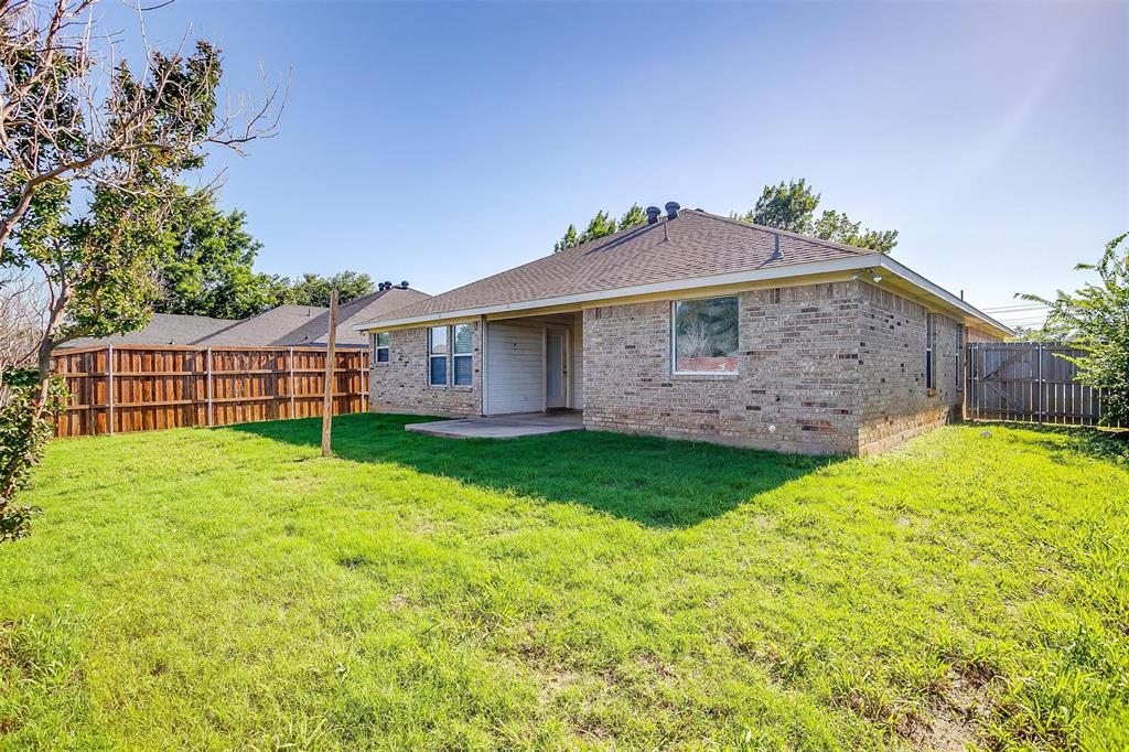 543 Thistle Meade Circle Burleson, TX 76028 - Photo 22 of 23 a view of a backyard with a garden