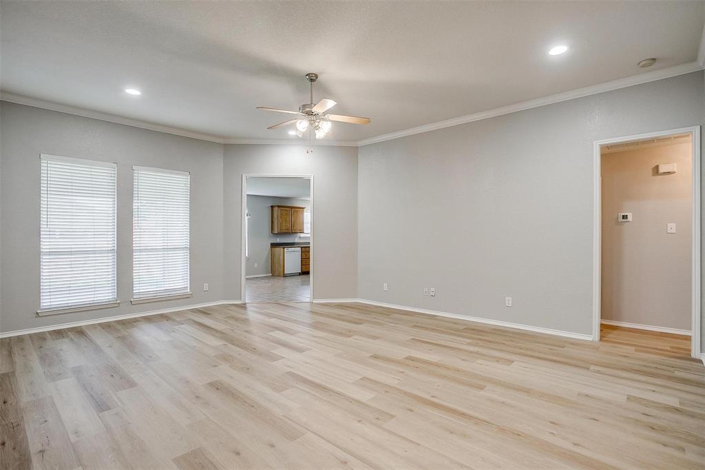 543 Thistle Meade Circle Burleson, TX 76028 - Photo 6 of 23 an empty room with wooden floor chandelier and windows