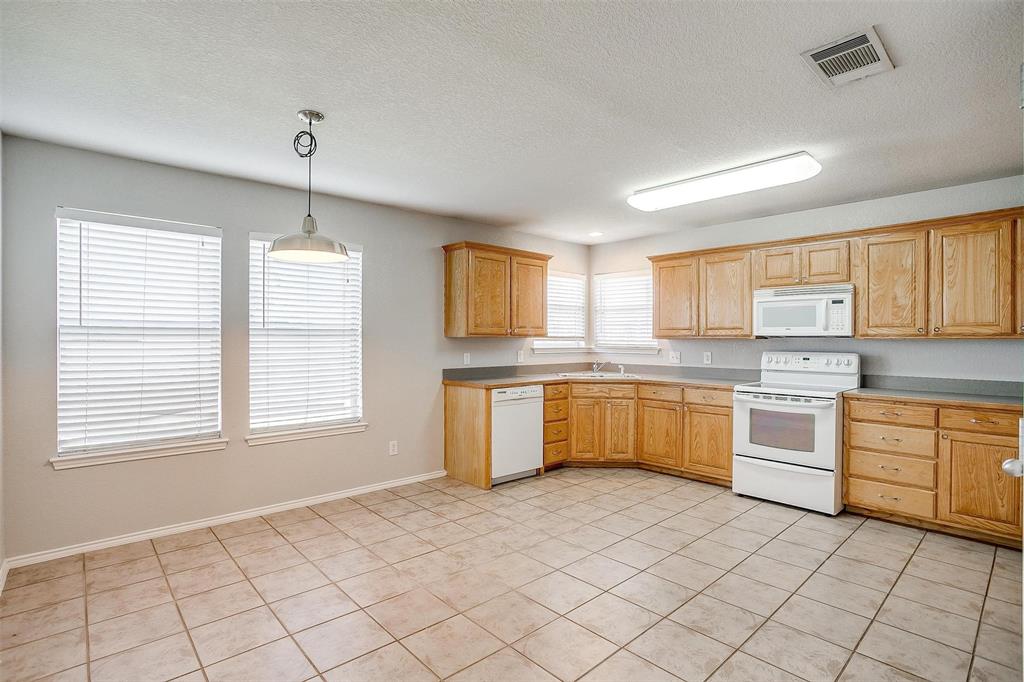 543 Thistle Meade Circle Burleson, TX 76028 - Photo 8 of 23 a large white kitchen with cabinets wooden floor and a sink