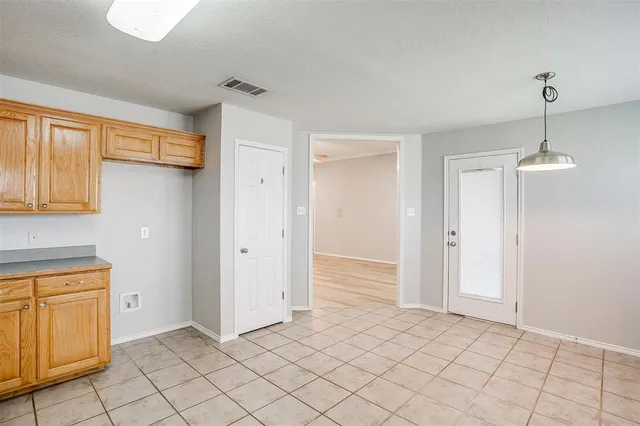 a view of a kitchen with wooden floor and chandelier