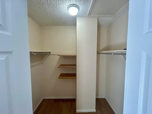 a spacious bathroom with a double vanity sink a mirror and a shower