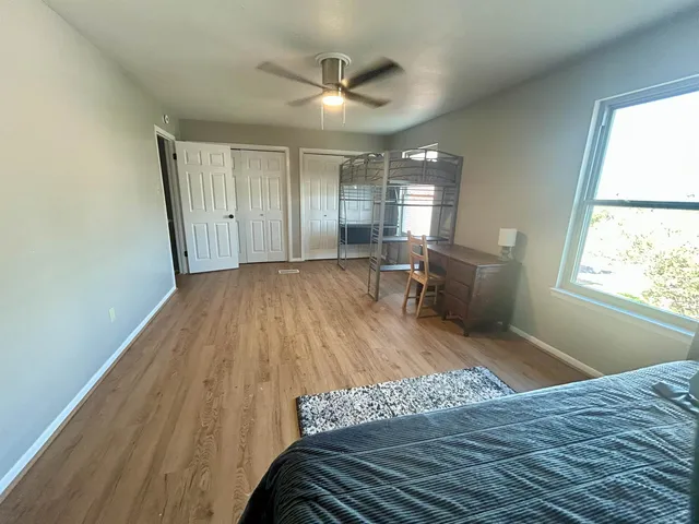 a view of a livingroom with furniture and a ceiling fan