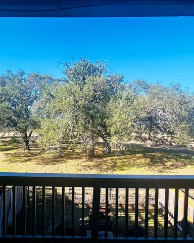 a view of a backyard with swimming pool and furniture
