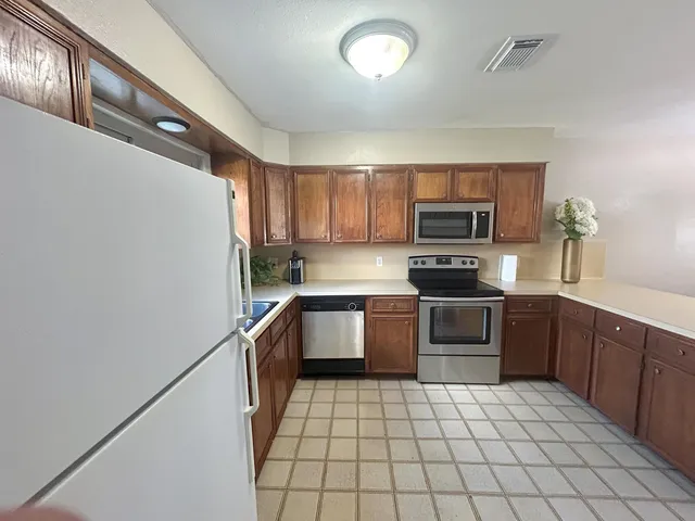 a living room with furniture and a kitchen