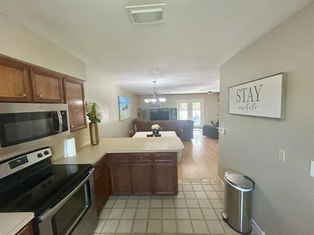 a dining room with furniture and chandelier