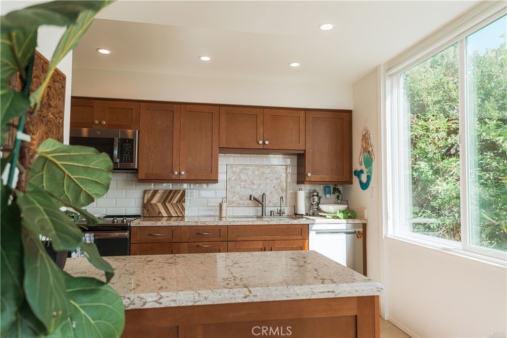 16 South 36th Place, Unit F Long Beach, CA 90803 - Photo 19 of 28 a kitchen with granite countertop a sink a counter top space and cabinets