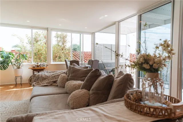 a living room with furniture fireplace and a large window