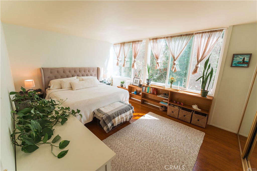 16 South 36th Place, Unit F Long Beach, CA 90803 - Photo 6 of 28 a spacious bedroom with a bed and a couch